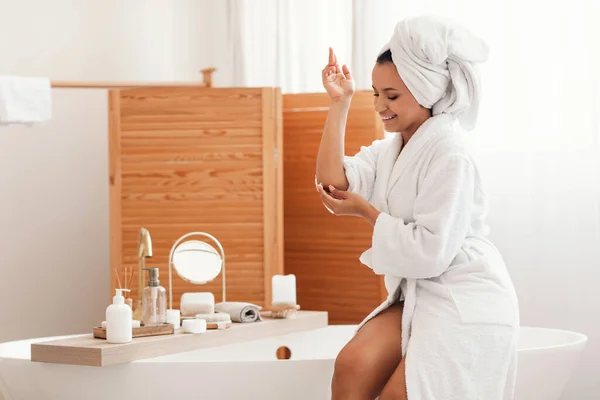 Skincare Cheerful Woman Applying Moisturizer Cream Elbow Moisturizing Skin Sitting — Zdjęcie stockowe