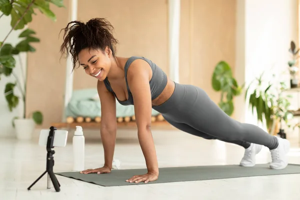 Young Black Lady Planking Home Watching Fitness Video Having Video — ストック写真