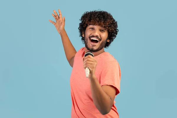 Joyful Curly Bearded Millennial Indian Guy Pink Shirt Singing Karaoke — Stok fotoğraf