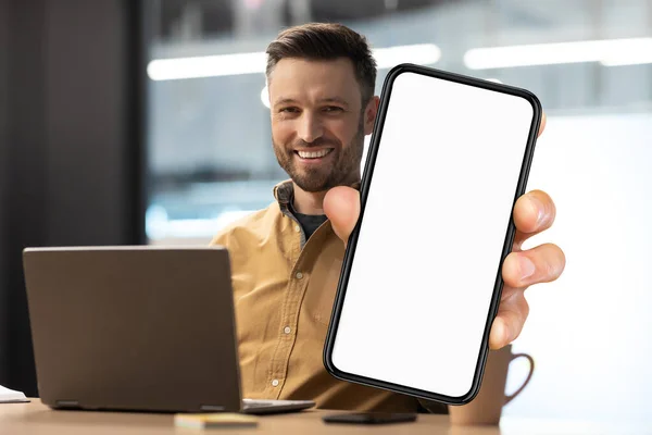 Business Offer Smiling Millennial Man Demonstrating Big Blank Smartphone While — Stok fotoğraf