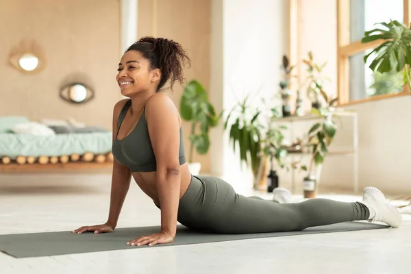 Smiling Black Lady Practicing Yoga Doing Ardha Bhudjangasana Sphinx Exercise — Stockfoto