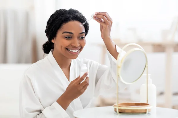 Skincare Cosmetics Beautiful Black Woman Applying Moisturizing Face Serum Dropper — Stok Foto