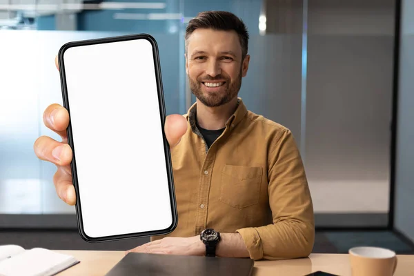Handsome Young Businessman Showing Big Blank Smartphone While Sitting Desk — Stok fotoğraf