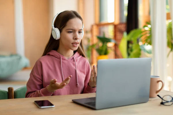 Online Communication Teenage Girl Talking Laptop Webcamera Wearing Wireless Headphones — Fotografia de Stock