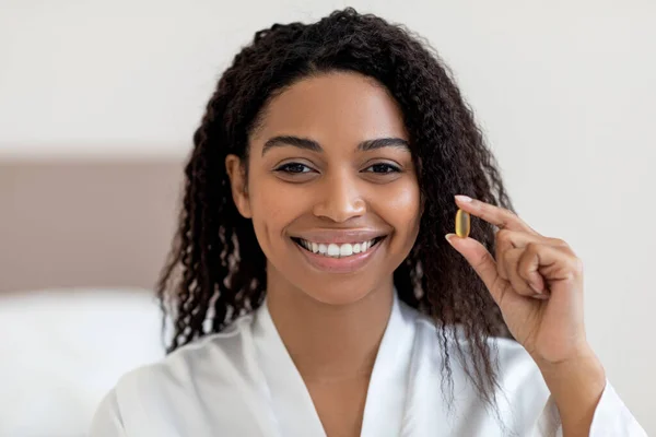 Beautiful Young Black Woman Holding Vitamin Pill Capsule Smiling Camera — Φωτογραφία Αρχείου