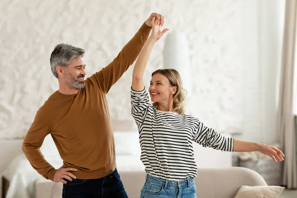 Positive Middle Aged Husband Wife Dancing Having Fun Home Couple — Stockfoto