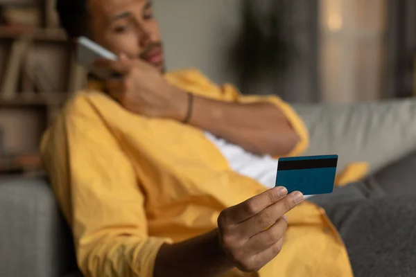 Young African American Man Holding Credit Card Calling Bank Client —  Fotos de Stock