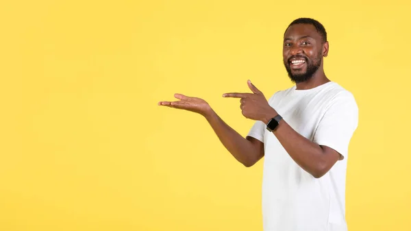 Look Toothy Black Guy Pointing Finger Hand Holding Invisible Object —  Fotos de Stock
