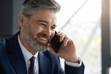 Closeup Shot Of Handsome Smiling Middle Aged Businessman Talking On Mobile Phone, Confident Male Entrepreneur In Suit Having Pleasant Business Call, Enjoying Corporate Communication, Copy Space