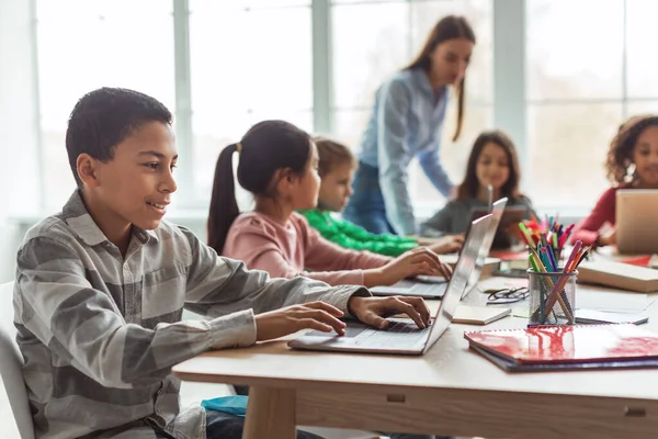 Cheerful Black Schoolboy Using Laptop Computer Learning Online Diverse Classmates —  Fotos de Stock