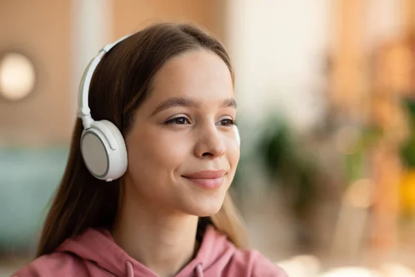 Relaxed Positive Teenage Girl Wearing Wireless Headset Listening Music Looking — Stok fotoğraf