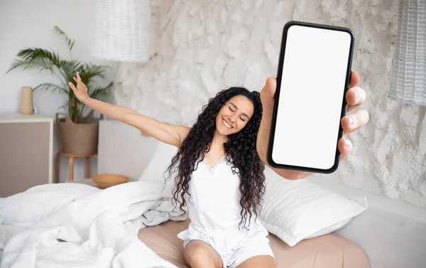 Beautiful Young Woman Holding Blank Smartphone While Stretching Bed Morning — Foto Stock