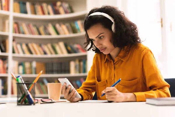 Remote Learning Lady Wireless Headphones Sitting Desk Library Using Smartphone — Fotografia de Stock