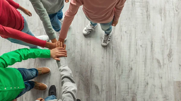 Teambuilding Unrecognizable Kids Putting Hands Together Standing Indoors Top View — Stock Fotó