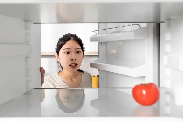 Upset Millennial Chinese Woman Looking Lonely Tomato Her Fridge Starving — Fotografia de Stock