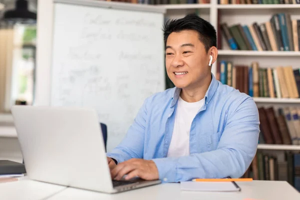 Cheerful Korean Teacher Man Typing Laptop Computer Preparing Online Lecture — Stock Fotó