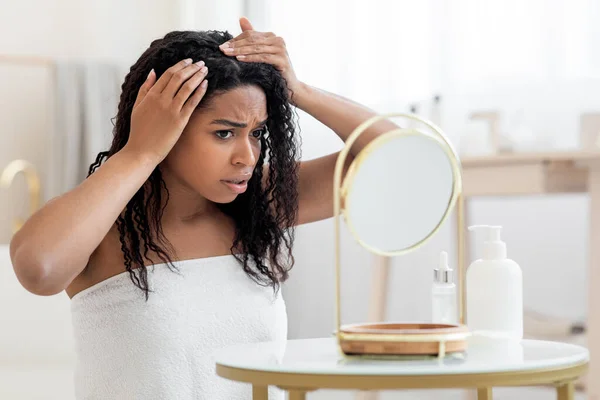 Dandruff Problem. Upset African American Female Looking To Mirror At Her Hair Roots, Frustrated Young Black Woman Wrapped In Towel After Bath Suffering Dry Flaky Scalp, Closeup Shot With Free Space