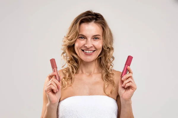 Trendy Makeup Beautiful Middle Aged Woman Holding Two Lip Gloss — 图库照片