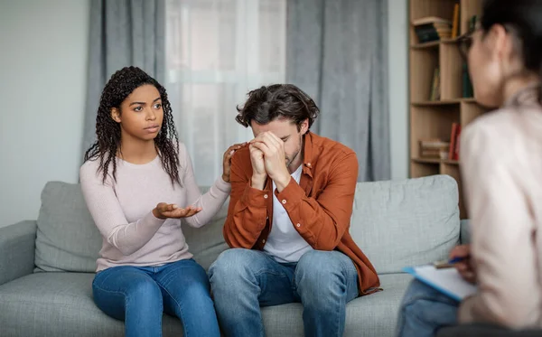 Sad Black Wife Calms Depressive European Husband Consultation Psychologist Couple — 스톡 사진