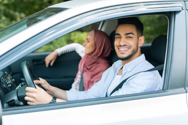 Satisfied Millennial Arab Male Driving Steering Wheel Looks Camera Rides — Stockfoto