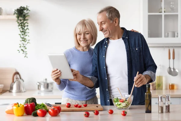 Senior Couple Reading Food Blog Digital Tablet Cooking Together Healthy — Stockfoto
