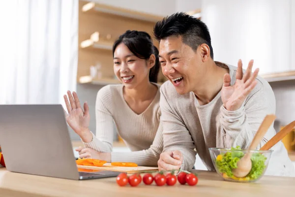Happy Asian Couple Having Video Chat Friends Family While Cooking — Stockfoto