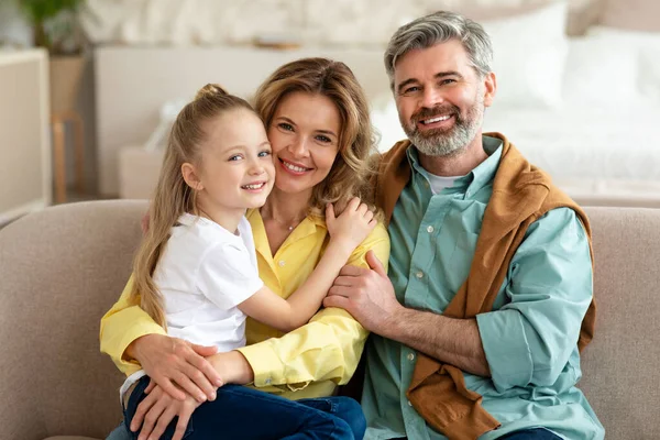 Happy Family Little Daughter Posing Embracing Smiling Looking Camera Sitting — Fotografia de Stock