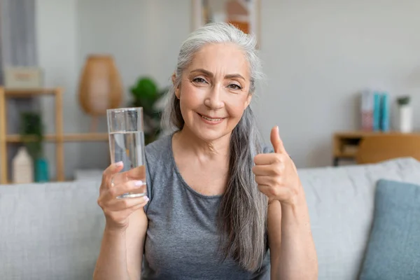 Happy Pretty Caucasian Senior Gray Haired Female Holds Glass Water — Zdjęcie stockowe