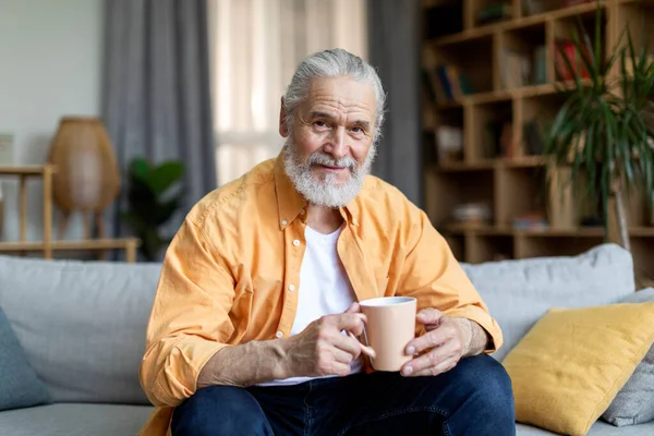 Cheerful Attractive Grandfather Sitting Couch Holding Mug Drinking Herbal Tea — Stock Photo, Image