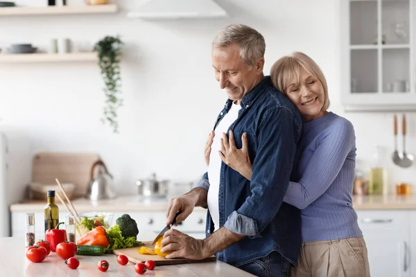 Happy Wife Attractive Senior Lady Hugging Her Husband Chef Cooking — Foto de Stock
