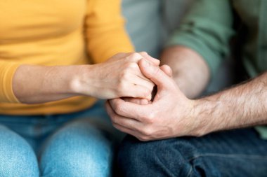 Cropped Shot Of Loving Middle Aged Couple Holding Hands Together, Unrecognizable Mature Man And Woman Supporting Each Other And Bonding At Home, Spouses Having Tender Moments, Closeup