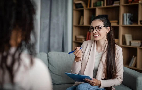 Smiling European Millennial Woman Doctor Glasses Consults Black Lady Patient — Zdjęcie stockowe