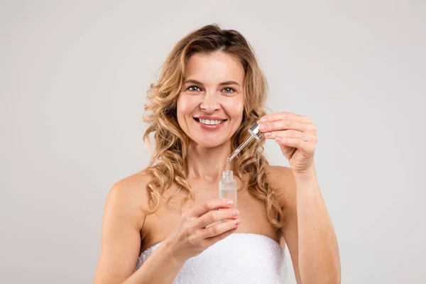 Skin Rejuvenation Beautiful Middle Aged Female Holding Bottle Face Serum — стоковое фото