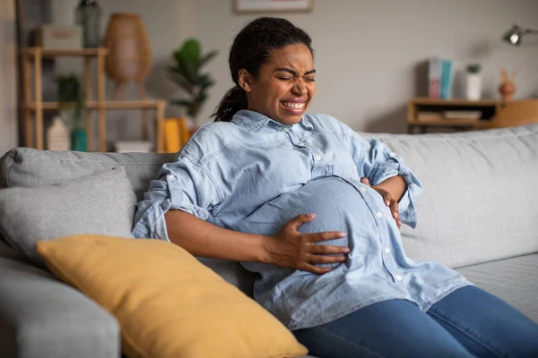 Pregnant Black Female Suffering Pain Having Painful Spasm Touching Belly — стоковое фото