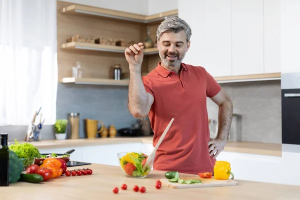 Funny Handsome Middle Aged Man Salting Food Smiling Pretending Professional — Foto Stock