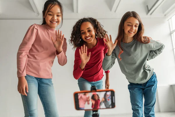 Hello Three Happy Diverse Girls Waving Hands Smartphone Tripod Making — Stock Fotó