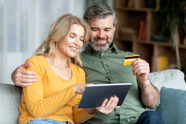Happy Middle Aged Couple Making Online Payments Digital Tablet Credit — Φωτογραφία Αρχείου
