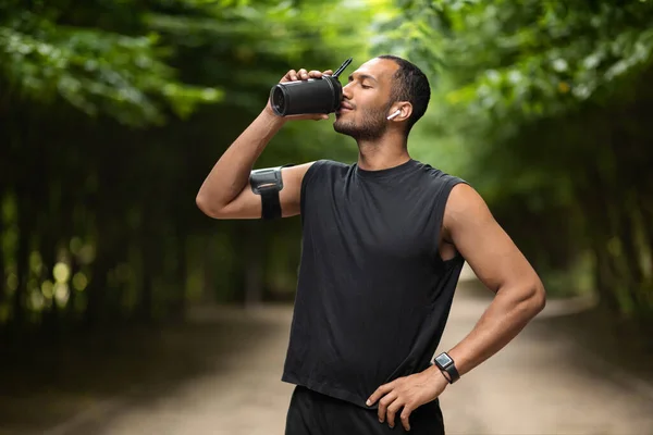 Sporty Young Black Man Drinking Protein Cocktail Training Public Park — стоковое фото