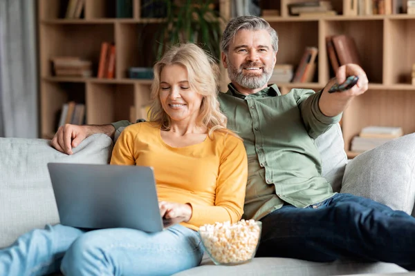 Happy Mature Couple Resting Couch Home Man Watching Woman Using — Stock fotografie