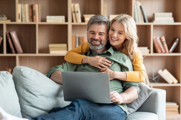 Smiling Middle Aged Spouses Spending Time Laptop Living Room Happy — 图库照片