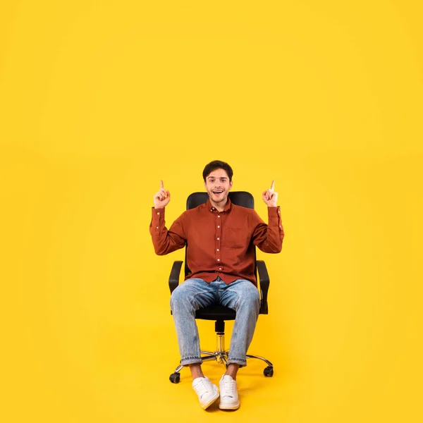 Happy Man Pointing Fingers Advertising Offer Smiling Camera Sitting Chair — Fotografia de Stock