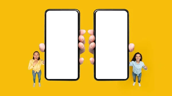 Two Happy Ladies Showing Big Cellphones Empty Screens Advertising Mobile — Stock fotografie
