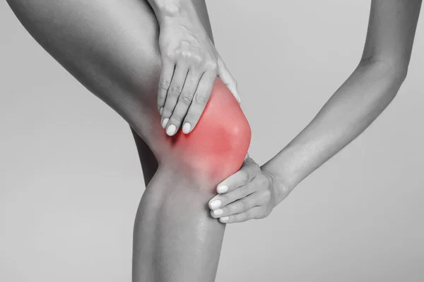 Young Woman Suffering Knee Pain Pressing Hands Sore Spot Highlighted — Stock Photo, Image