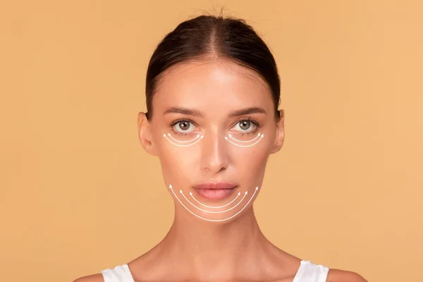 Plastic surgery woman face. Young lady with perforation lines on her face before plastic surgery operation, female posing over beige studio background