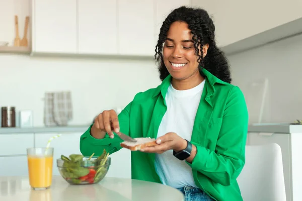 Felice Afroamericano Signora Mangiare Panino Avendo Colazione Seduta Tavola Cucina — Foto Stock