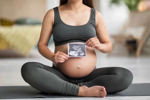 Unerkennbare Junge Schwangere Frau Sitzt Auf Yogamatte Und Demonstriert Baby — Stockfoto