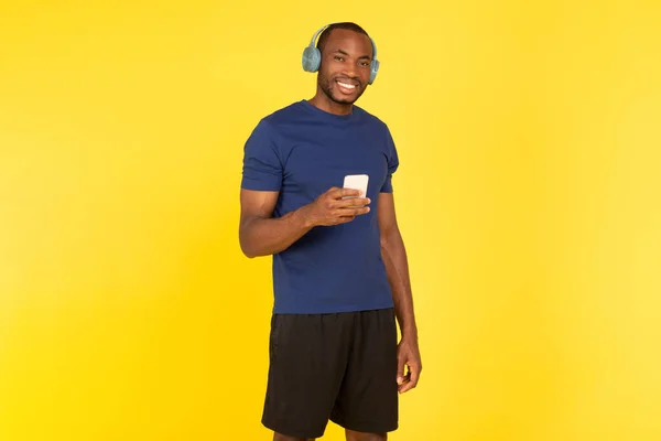 Cheerful African American Man Listening Music Holding Cellphone Wearing Wireless — Stok Foto