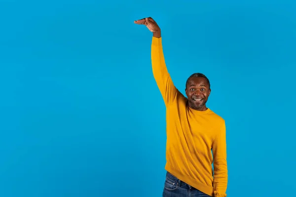 Šťastný Afroameričan Dospělý Muž Ležérní Oblečení Ukazující Výšku Něčeho Neviditelného — Stock fotografie