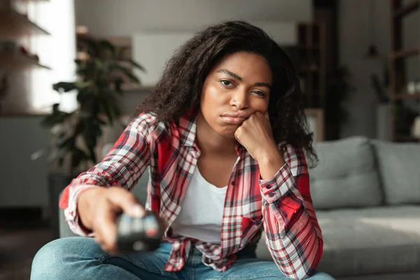 Gelangweilte Traurige Hübsche Afrikanische Amerikanerin Mit Fernbedienung Fernsehnachrichten Oder Film — Stockfoto