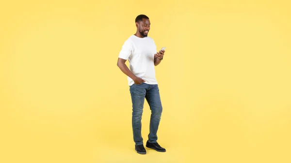 Sarı Arka Planda Mesajlaşırken Iletişim Kurarken Mutlu Siyah Erkek Kullanım — Stok fotoğraf
